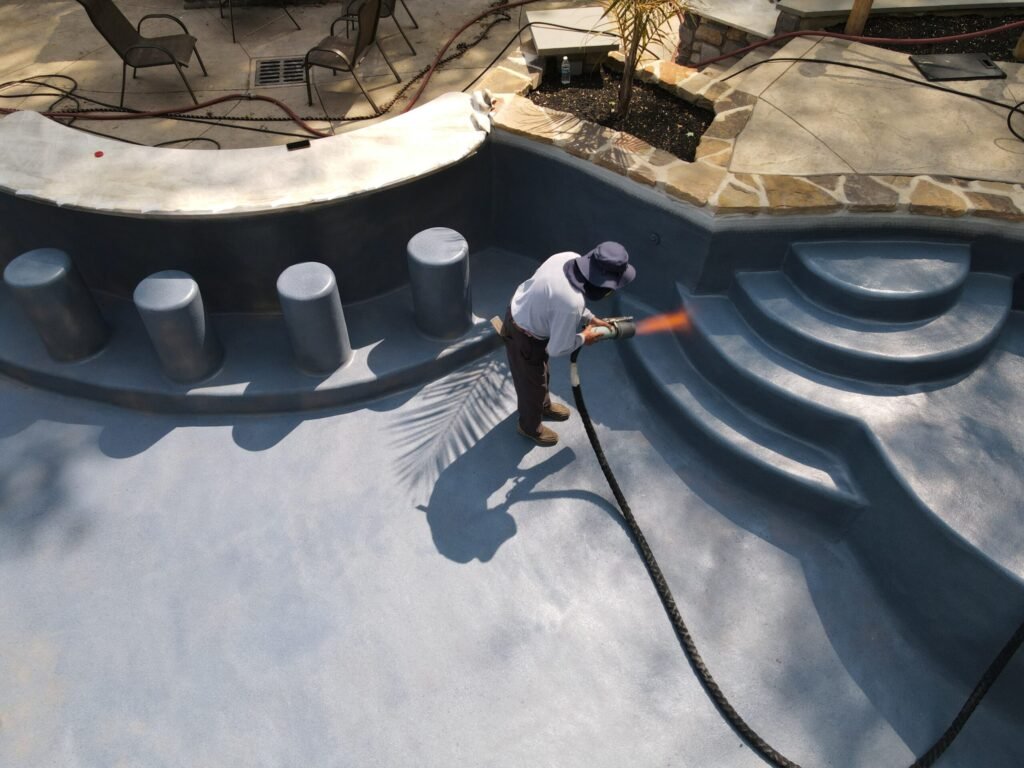 Pool surface preparation before coating installation.