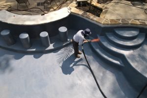 Pool surface preparation before coating installation.